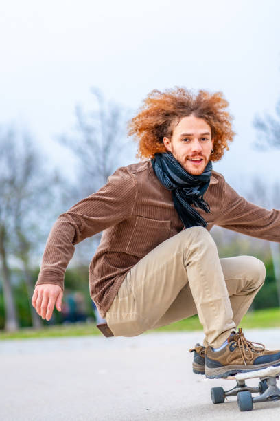 istock Happy young man skateboarding in a park 1852452219
