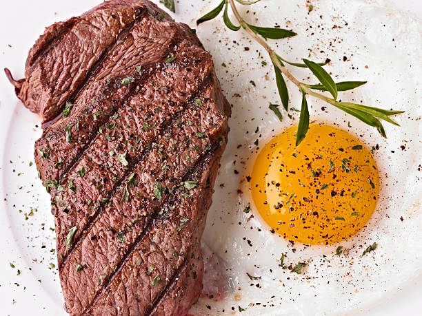 Steak and sunny side up egg with seasoning Steak and Egg steak and eggs breakfast stock pictures, royalty-free photos & images