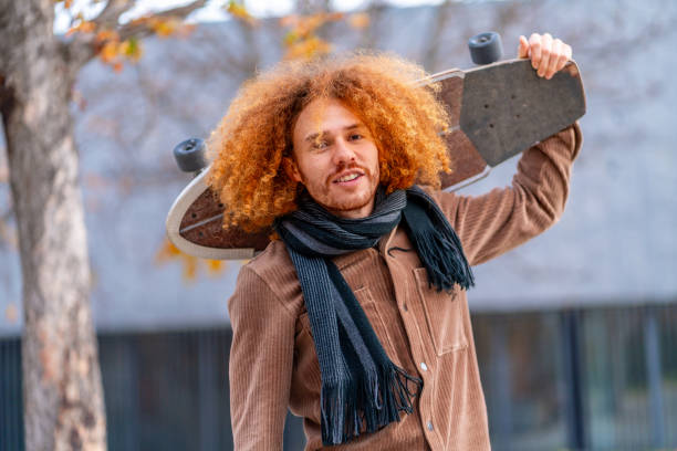 istock Cool man carrying a skateboard in the city 1852457576