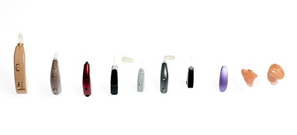 Hearing aids, different kinds Modern varied hearing aids models in a row. deafness photos stock pictures, royalty-free photos & images