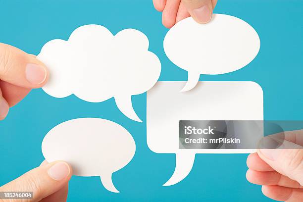 Four Blank White Conversation Speech Bubbles Stock Photo - Download Image Now - Speech Bubble, Four Objects, Human Hand