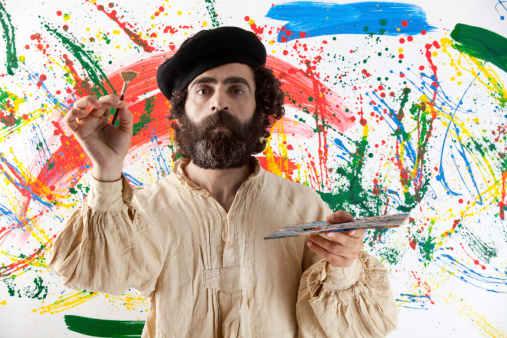 Artist adult man standing before painting