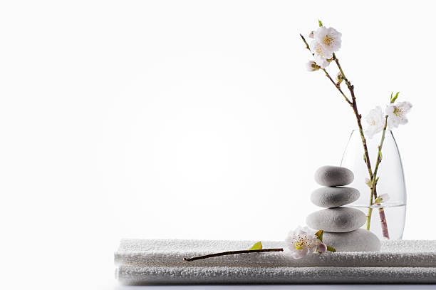 Clean White Spa Background "SEVERAL MORE IN THIS SERIES. Clean zen spa background concept, with white massage stones, cherry blossoms and towel.  Copy space." aromatherapy photos stock pictures, royalty-free photos & images