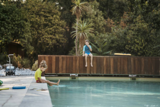 Free Stock Photo of Two Young Girls Sitting on the Edge of a Swimming ...