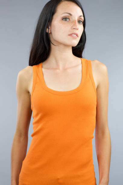 istock Young woman with long orange tank top 185247593