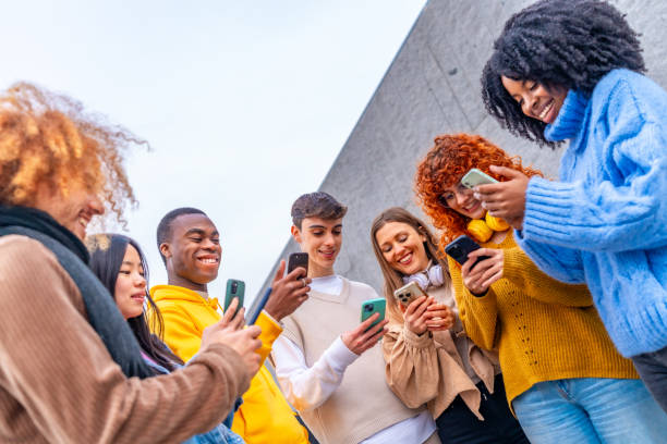 istock Group of friends using phone in the city 1852476398