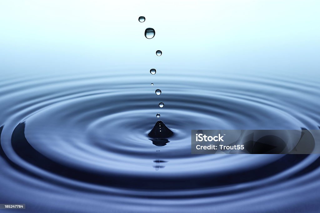 Falling small drops of water Blue Stock Photo