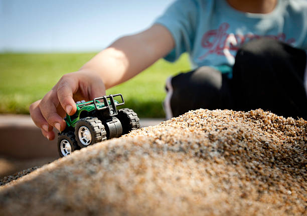 Old toys in a sandbox.