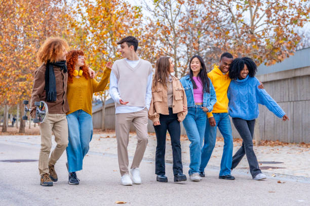 istock Multi-ethnic friends chatting and strolling along the street 1852481679