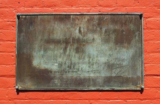 Blank Metal Plaque or Sign on painted red brick.