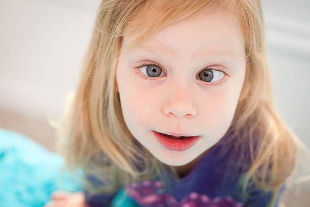 Close Up of  Goofy Little Girl Crossing Her Eyes stock photo