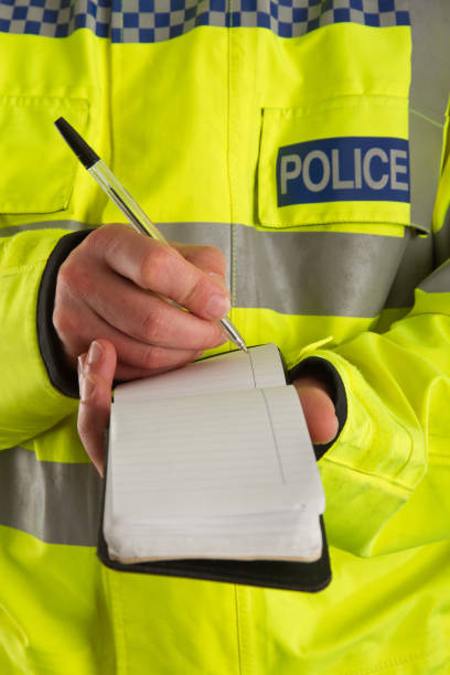 Policeman taking details A UK policeman taking notes, possibly at a crime scene. metropolitan police stock pictures, royalty-free photos & images