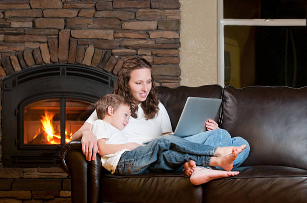 istock A mother and son resting on a couch using a laptop 185249285