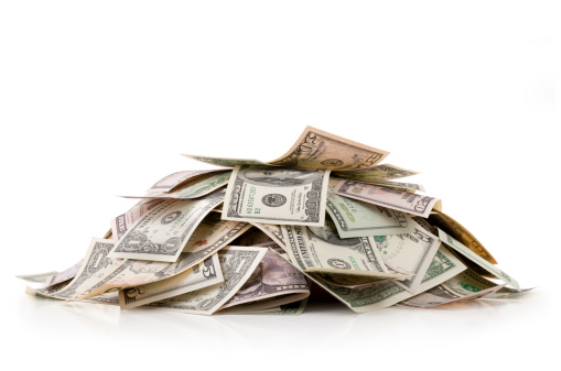 Heap of money. Dollar bills. Photo with clipping path.
