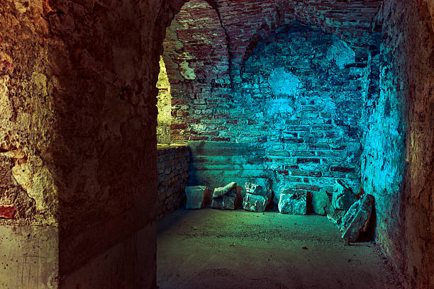Old stone arcades in a derelict, abandoned castle, blue flash illumination.