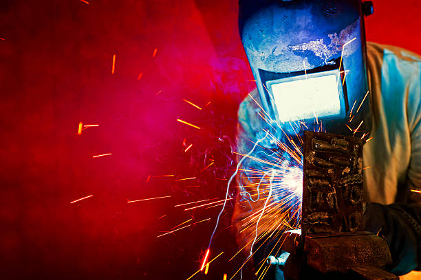 Welder welding, sparks fly. stock photo