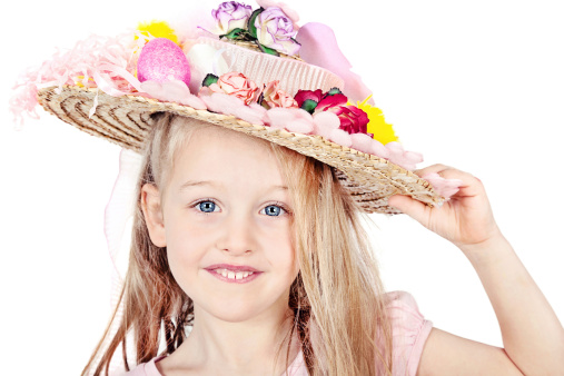 Cute 5 year old little girl wearing a homemade decorated Easter hat