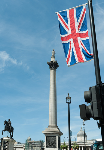 London Trafalgar Square with Nelson's Column and Union Jack flag.