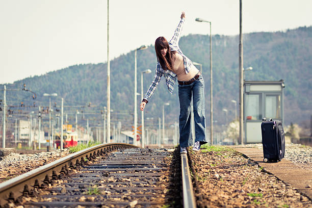 istock Young adults waiting at rural train station 185250789