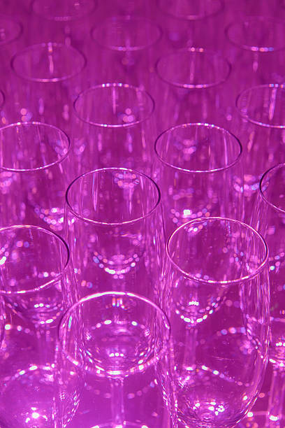 istock empty champagne flutes on a purple background 185250854