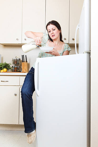 Busy woman quick breakfast stock photo