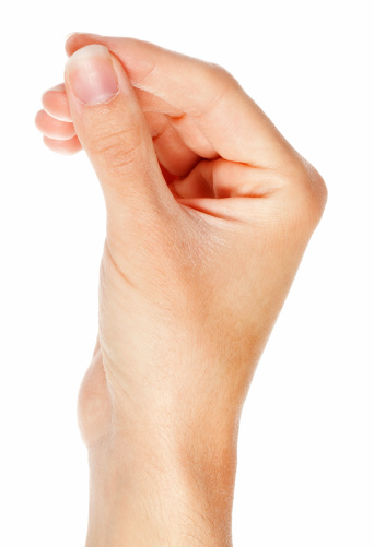Closeup of a man's hand with fingers crossed against a white background.