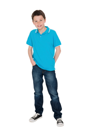 Portrait of cute little boy posing in casuals over white background. Vertical Shot.
