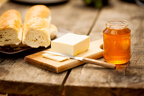 Honey breakfast Honey, bread and butter on a wooden table georgijevic stock pictures, royalty-free photos & images