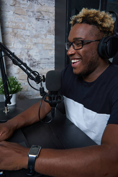 istock Radio DJ with glasses leads a popular program for listeners 1852522516