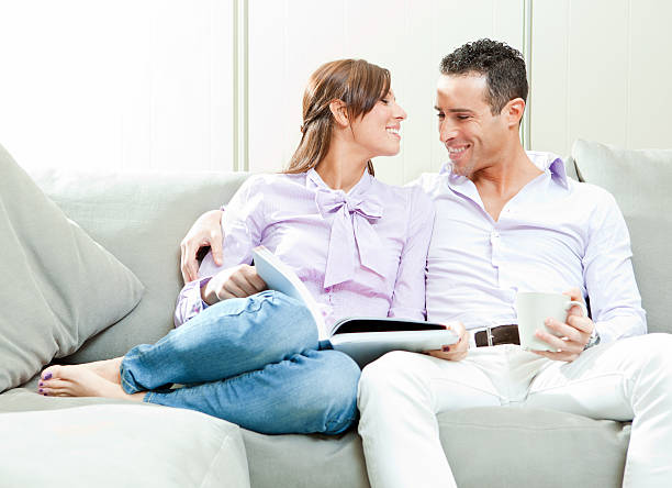 istock young couple having fun on the couch 185252463