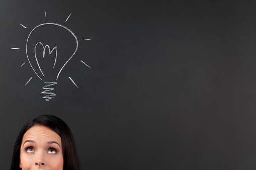 Young Woman Thinking a big idea on a blackboard