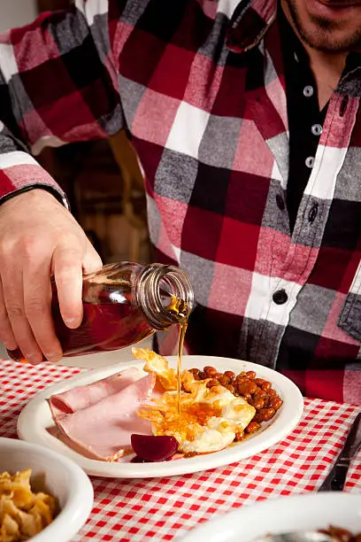 Photo of Men is pouring maple syrup