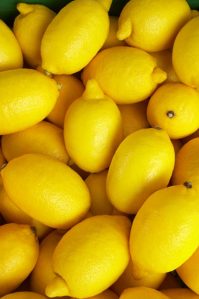 istock Yellow lemons at market background 185252713