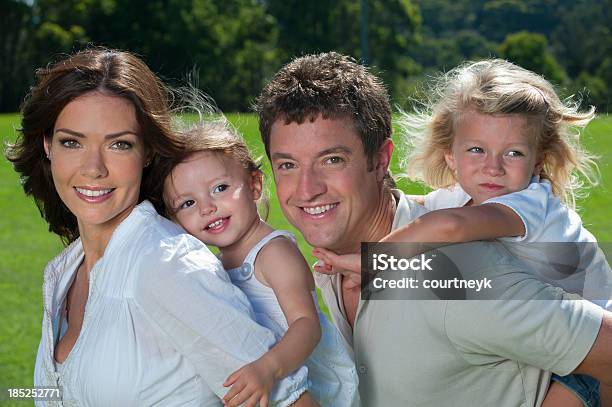 Glückliche Familie Im Park Stockfoto und mehr Bilder von Attraktive Frau - Attraktive Frau, Beide Elternteile, Blick in die Kamera