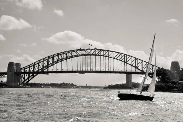 A sailing boat and, in the background, the Sydney harbour bridge. Tone mapping on sepia.