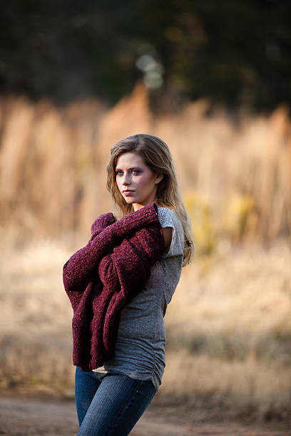 Girl wrapped in a sweater. stock photo