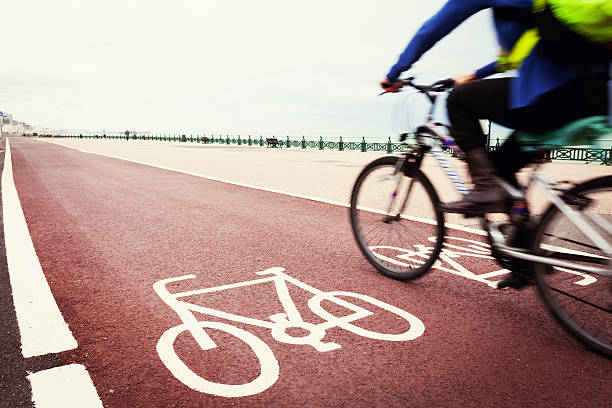 Red bicycle lane and bikers