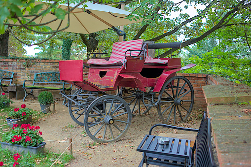 Street cafe in a picturesque area of Prague. Summer cafe in Visegrad. A photo zone with an antique vintage carriage attracts visitors.