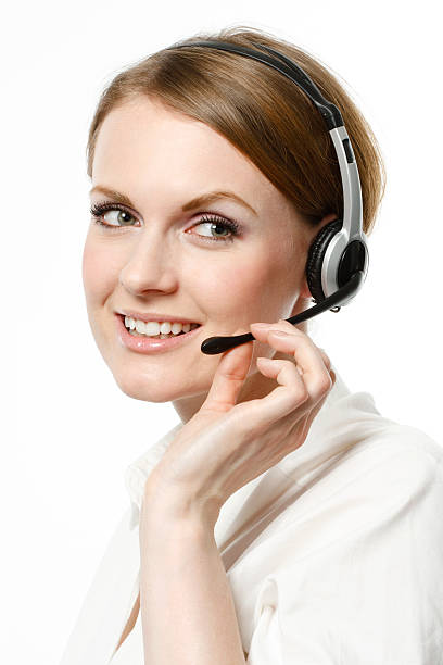 sorridente call center executive - white collar worker global communications side view headset foto e immagini stock