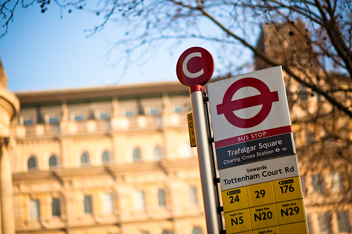 A sign showing all the busses that stop at the bus stop next to Trafalgar Square in London, England