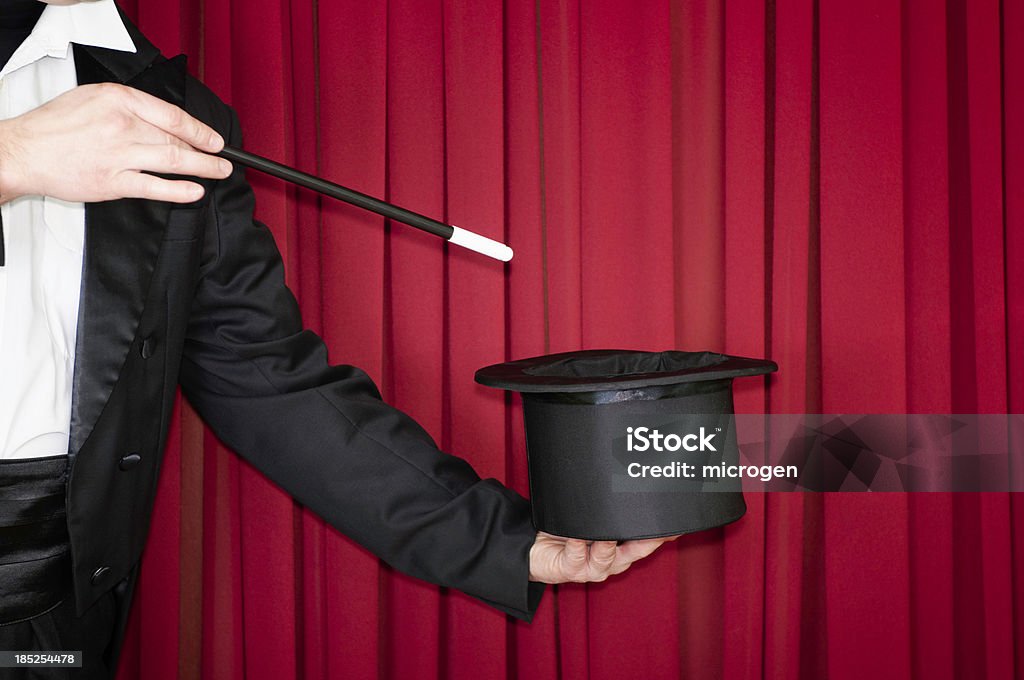 Magic trick on stage Magician on stage doing a trick with top hat Magician Stock Photo