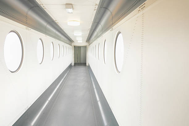 istock white circular windows at airport gangway with grey floor 185254620
