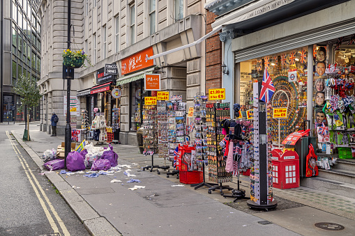 Museum Street, London, England - October 29th 2023:  Garbage in the street in front of a souvenir shop close to the British Museum