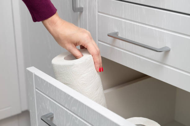 istock woman taking out paper towel from kitchen drawer. 1852549039