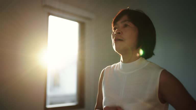 Asian woman jogging on treadmill in the morning.