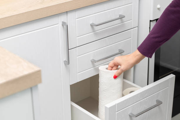 istock woman taking out paper towel from kitchen drawer. 1852550106