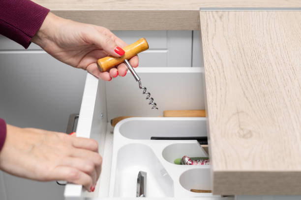 istock woman's hand takes out a corkscrew from a kitchen drawer. 1852551742