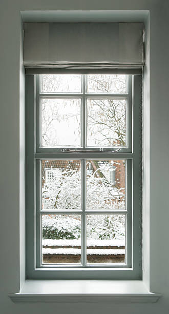 grey green window a traditional wood framed window from an older house painted grey-green and with a matching roller blind. The view outside is towards a wintery garden and a house covered in snow.Looking for a window Please see my window collection including cut-outs with clipping paths by clicking on the Lightbox Link below... window sill stock pictures, royalty-free photos & images