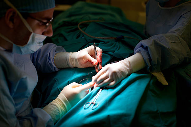 Doctors performing surgery stock photo