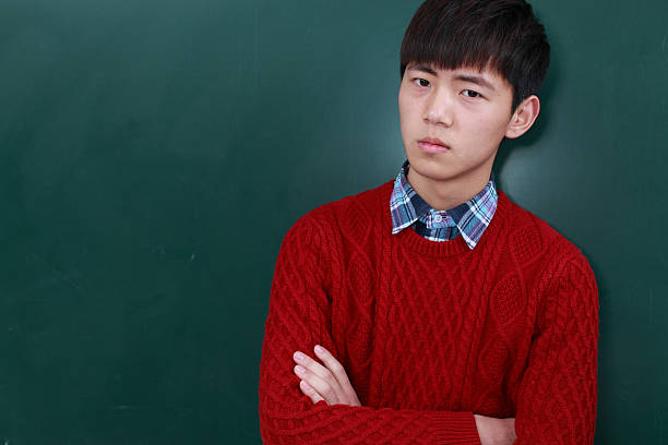 istock college student in front of black board 185255875